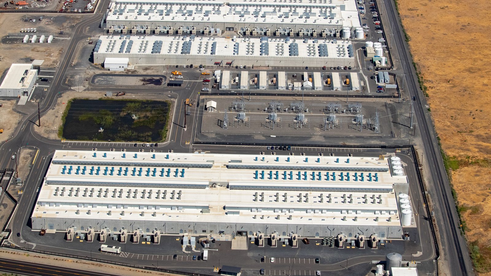 An aerial view of three Amazon Web Services data center buildings in Umatilla, Oregon.