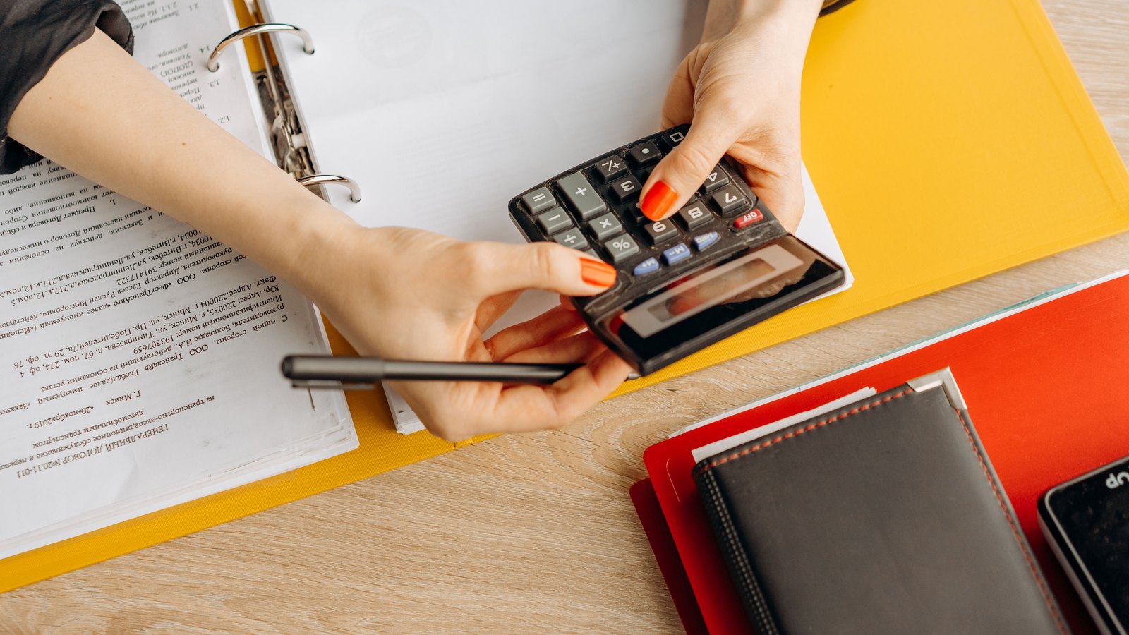 Financial paperwork and a calculator on a desk.