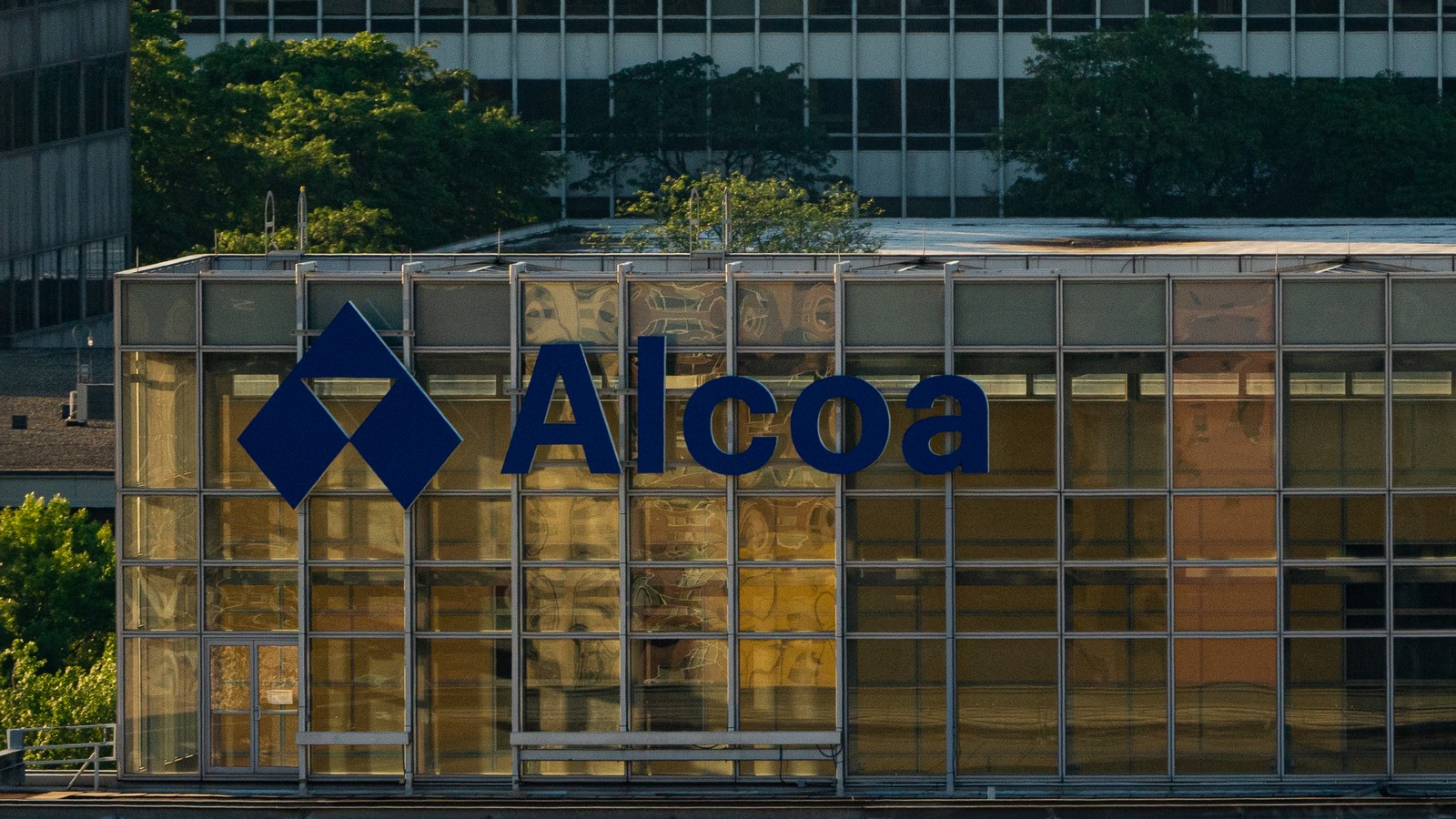 The Alcoa name and blue symbol on the glass facade of its Pittsburgh headquarters, photographed in June 2019.
