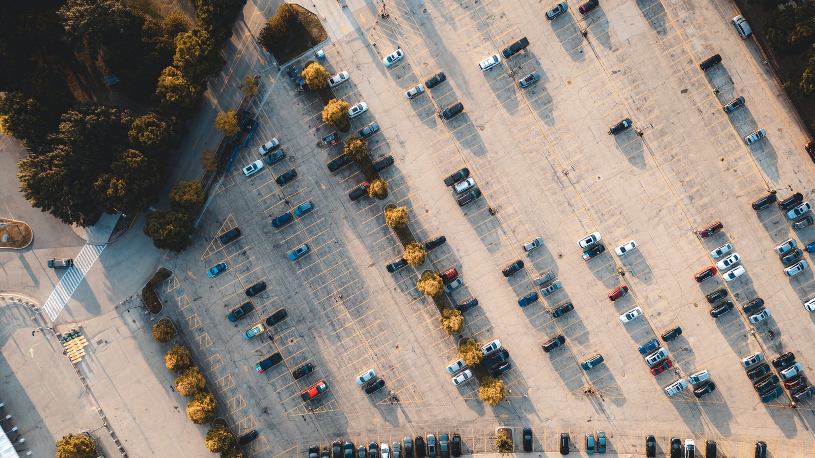 An aerial view of cars parked across a large outdoor lot.
