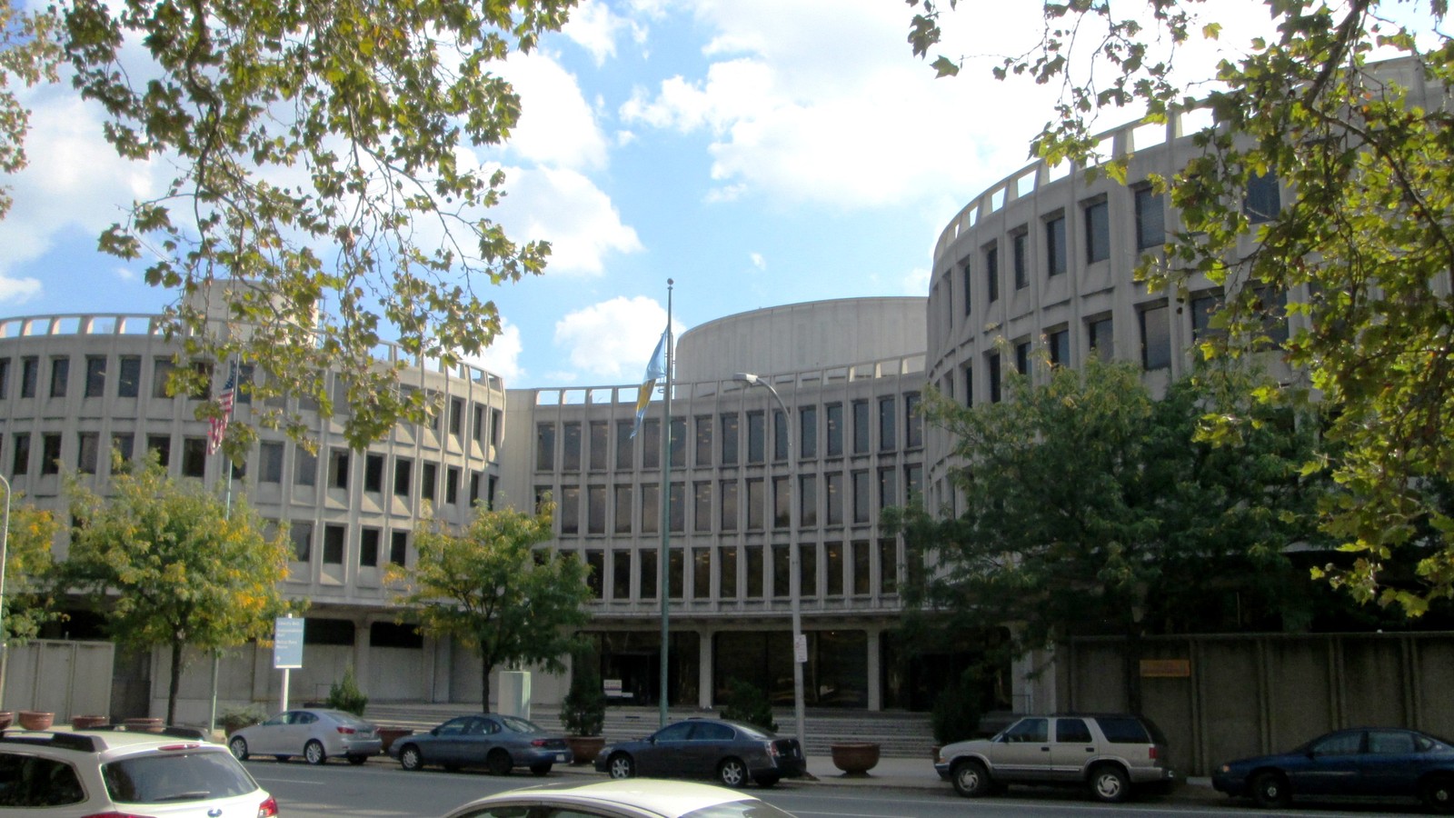 The circular concrete Philadelphia Police headquarters building viewed across a city street.