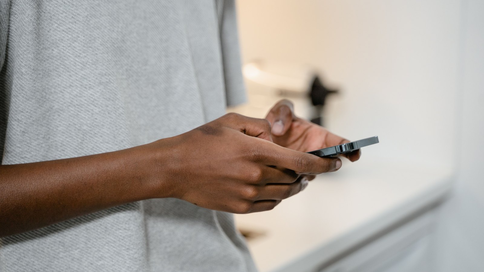 A photograph illustrating smartphone in hand.