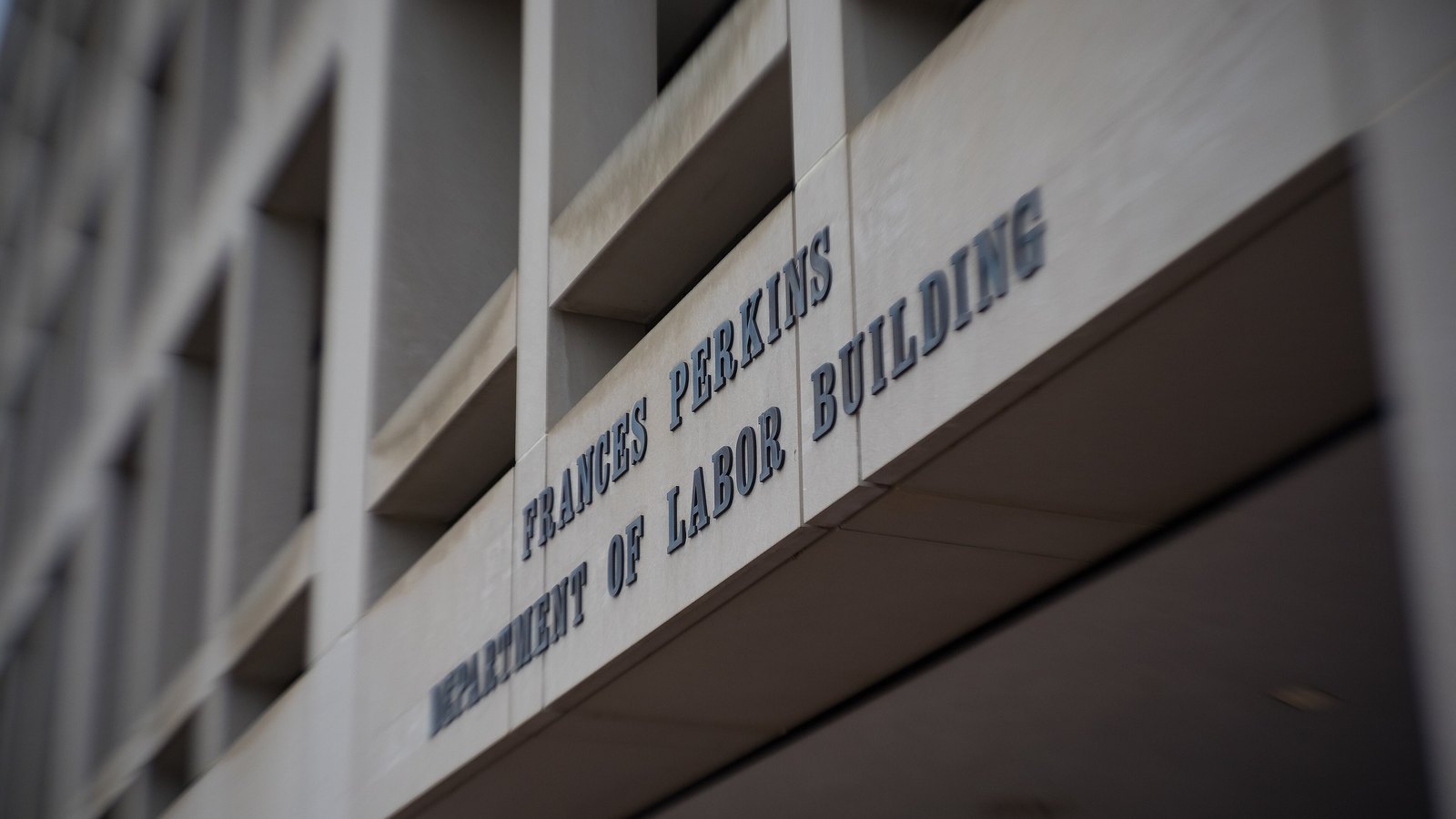 The names of the Frances Perkins Building and the United States Department of Labor appear above the building entrance in Washington.