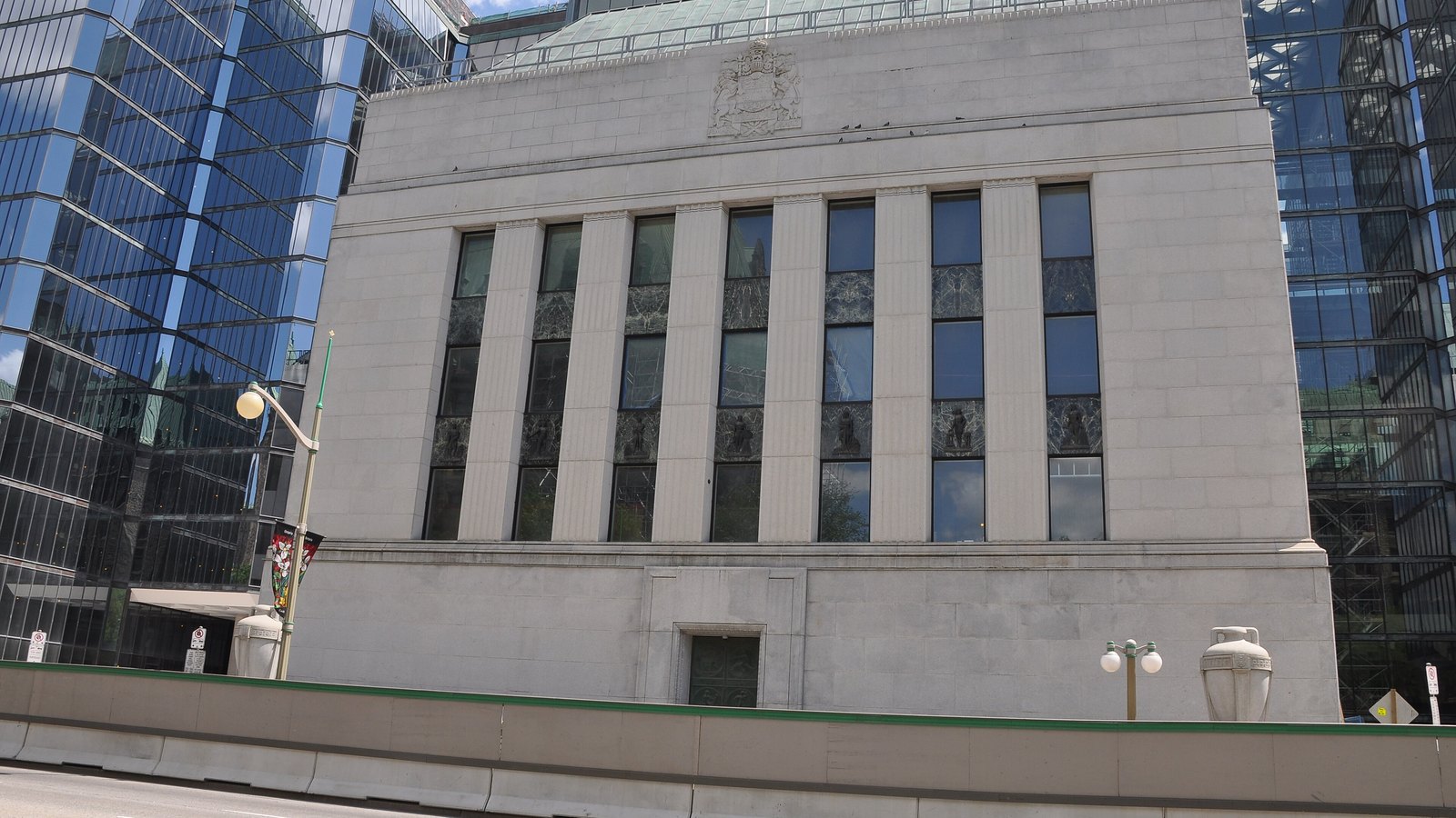 The Bank of Canada headquarters in Ottawa, with its original stone building framed by glass office towers.