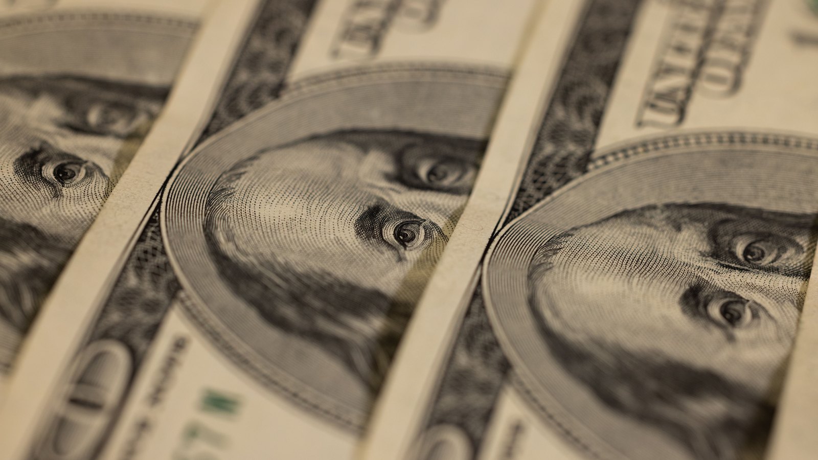 Close view of rows of United States hundred dollar bills.