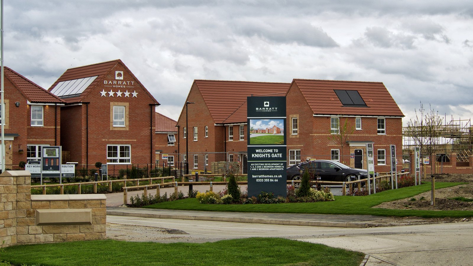 Newly built brick houses and Barratt Homes signs at the Knights Gate development in York.
