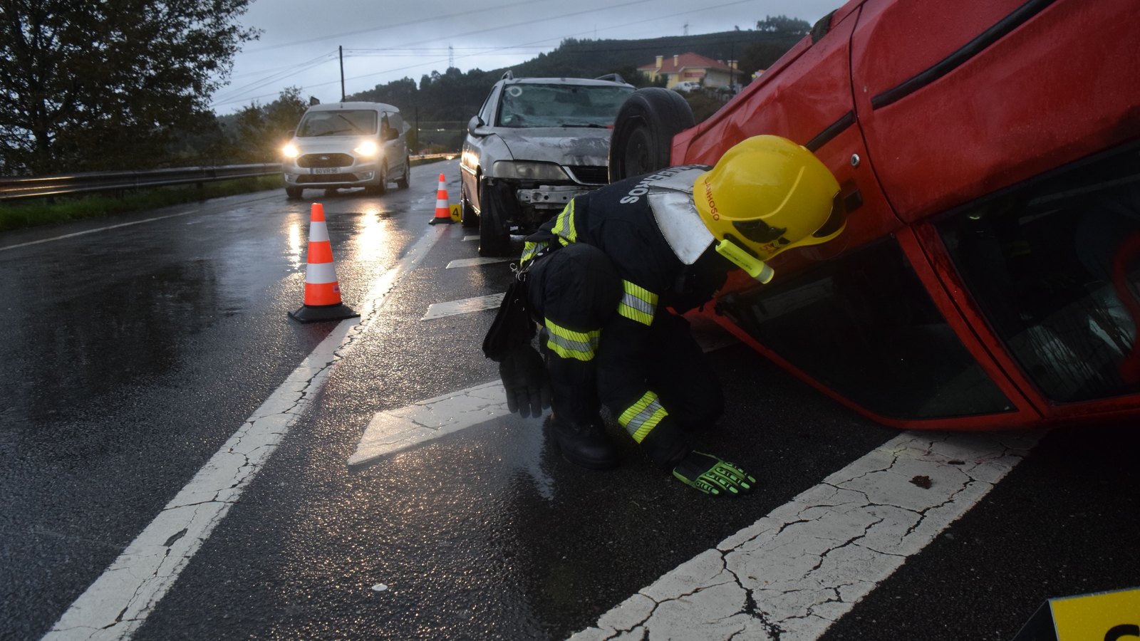 A photograph showing the aftermath of a vehicle crash on a road.