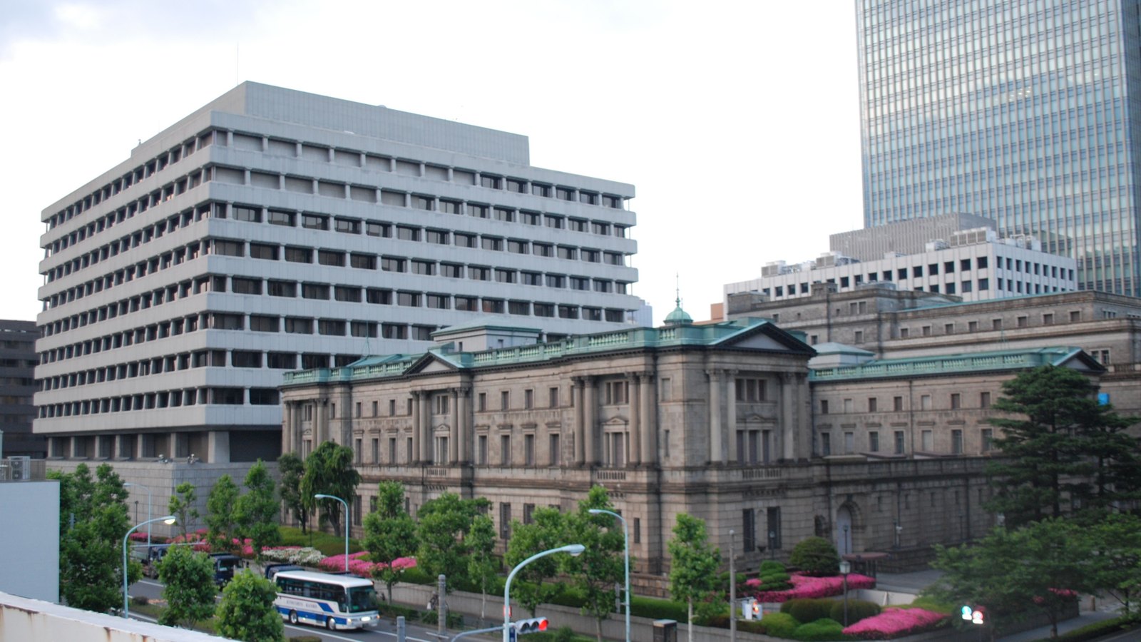 The historic Bank of Japan head office in Tokyo stands between modern office buildings.