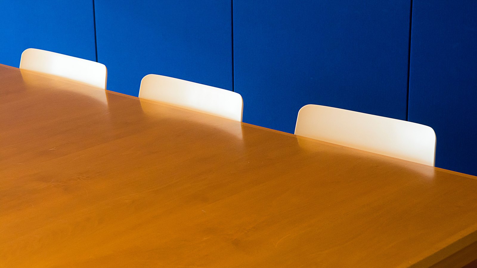 A photograph illustrating empty conference room table.