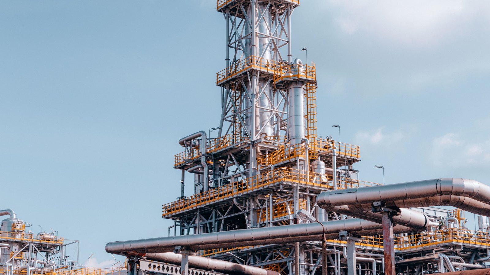 A photograph illustrating oil refinery pipes macro.