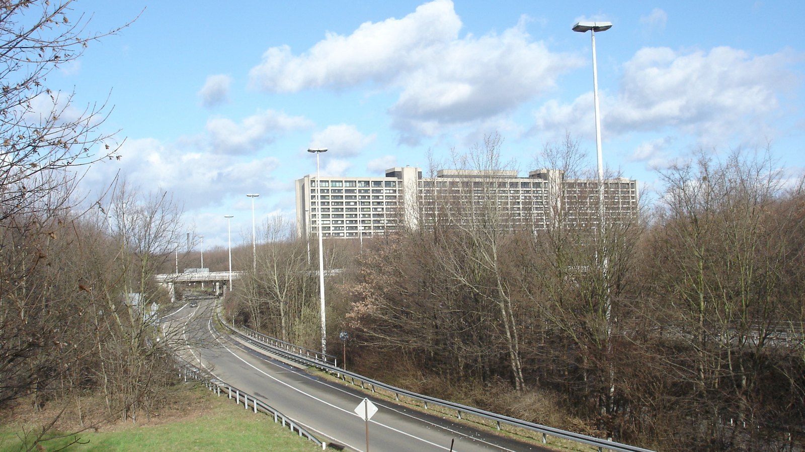 The Deutsche Bundesbank headquarters building in Frankfurt seen beyond a tree lined road.