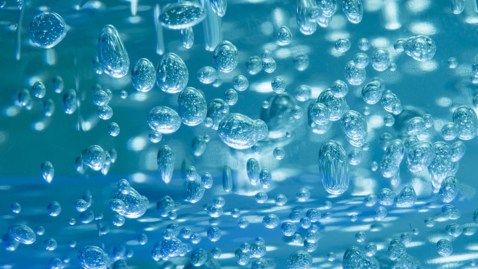 An abstract close up of many small bubbles suspended in blue tinted water, filling the whole frame, with pale highlights behind them. There is no text, signage, brand mark, person, food or identifiable place in the picture. A generic illustration of water, not a photograph of Cape Coral, of the SE 10th Avenue break or of anyone's tap, and not evidence about the condition of anyone's water. The bubbles are suspended rather than boiling, so the frame stands for water generally rather than showing the rolling boil the notice asks for.