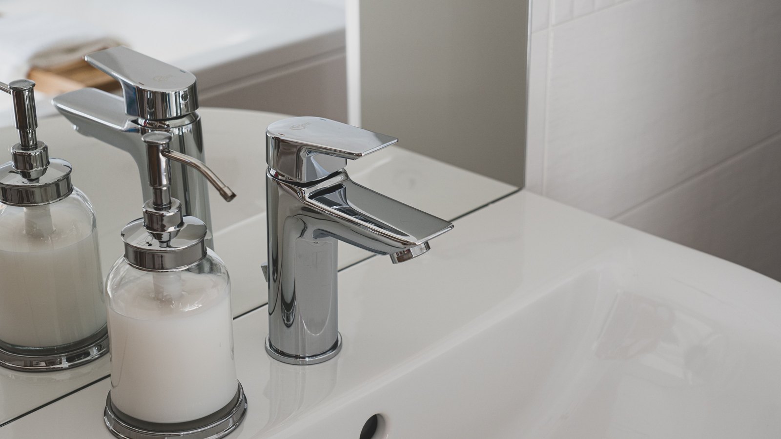 A chrome faucet and soap dispensers above a white sink, an illustration and not a photograph of the Cape Coral notices.