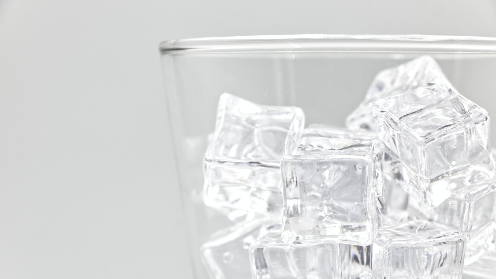 Ice cubes fill a clear drinking glass against a plain white background, not a photograph of these advisories.
