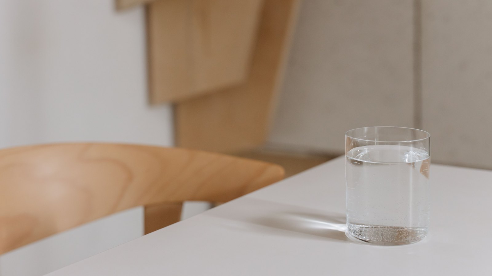 Clear glass of water on a light tabletop, not a photograph of this event.