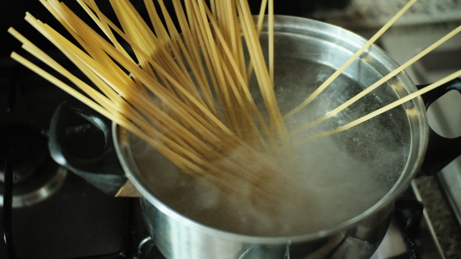 Spaghetti cooking in boiling water in a metal pot, an illustration and not a photograph of the Cape Coral advisories.