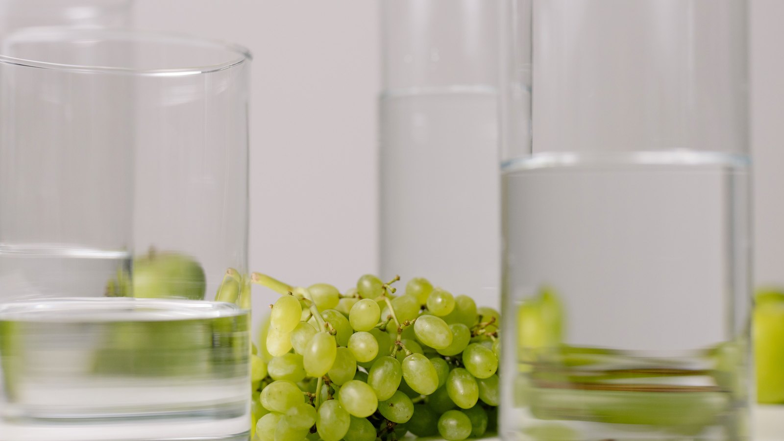 Clear glasses of water stand beside green grapes, not a photograph of these advisories.