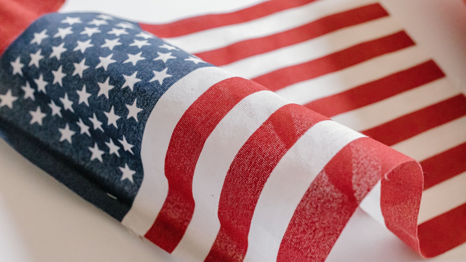 A photograph illustrating american flag stars and stripes closeup.