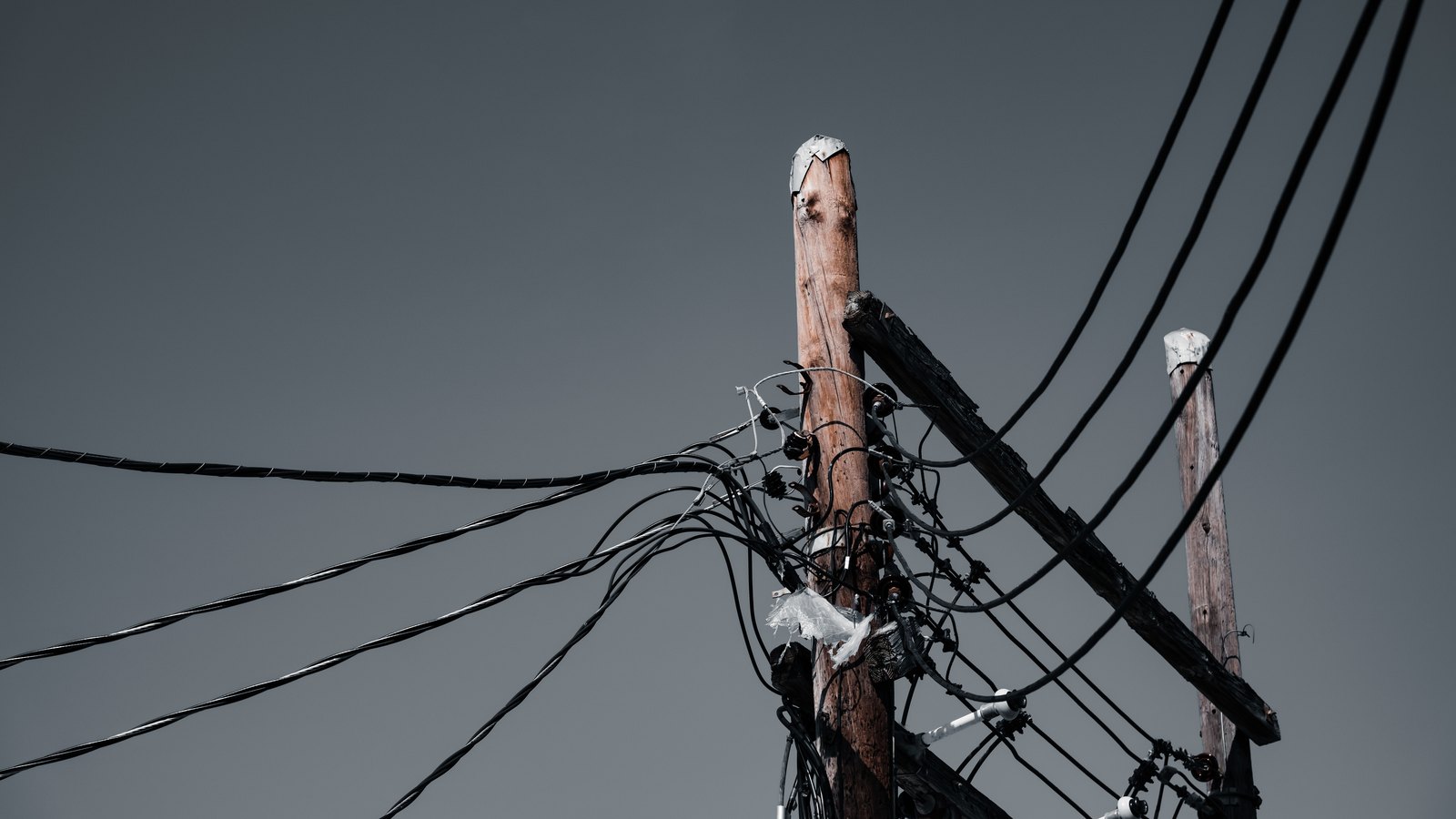 A photograph illustrating utility pole cable closeup.