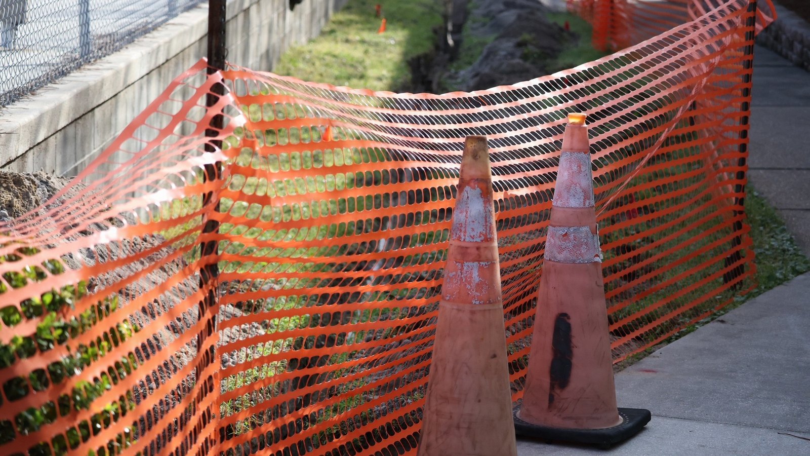 Orange safety fencing and traffic cones mark a generic Florida construction area, not a photograph of this event.