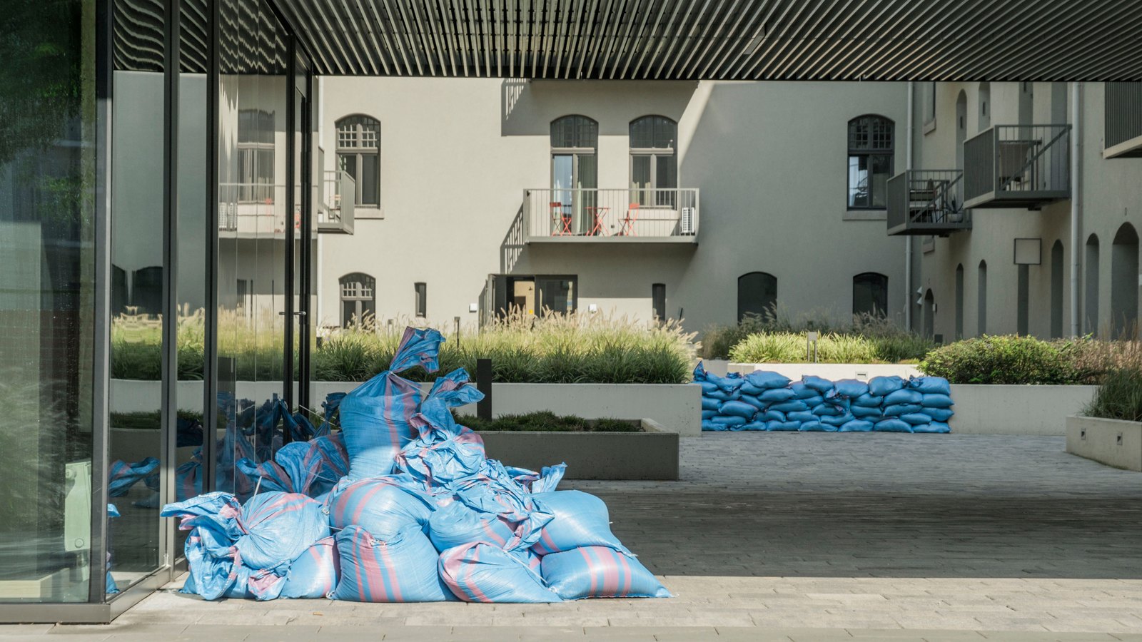 Sandbags stacked at a building entrance, not a photograph of this coastal flood statement.