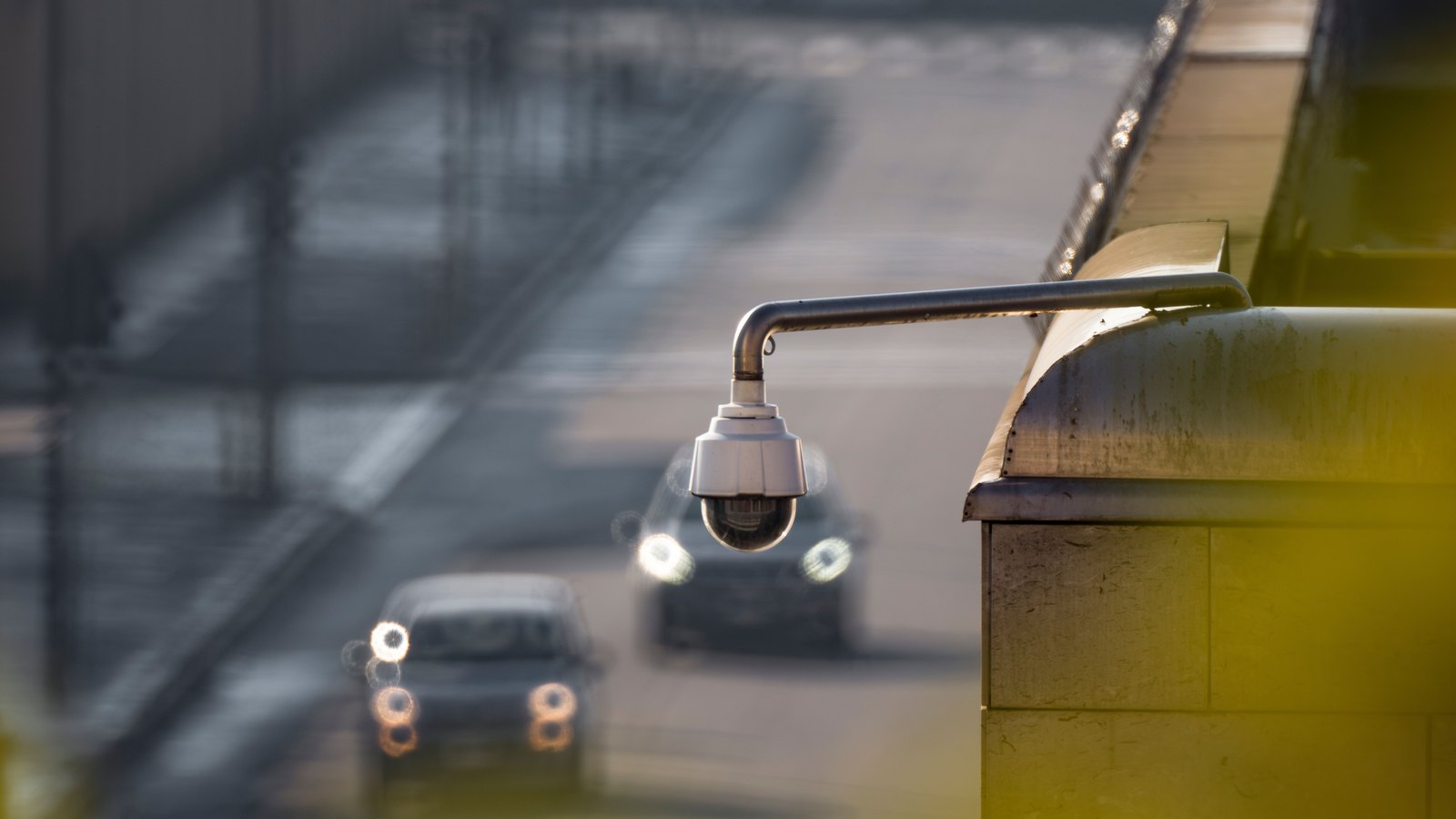 A surveillance camera above a roadway with blurred vehicles, not a photograph of this event.