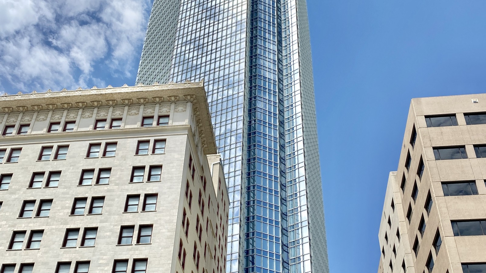 Devon Energy Center's glass tower rises between lower buildings in downtown Oklahoma City.