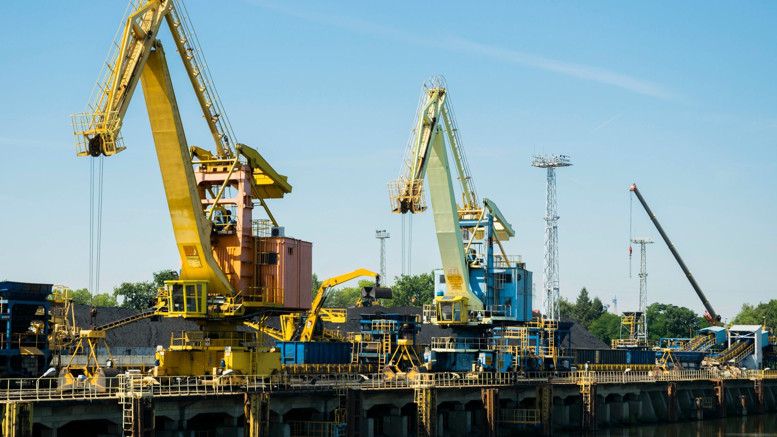 A photograph illustrating port gantry crane against sky.