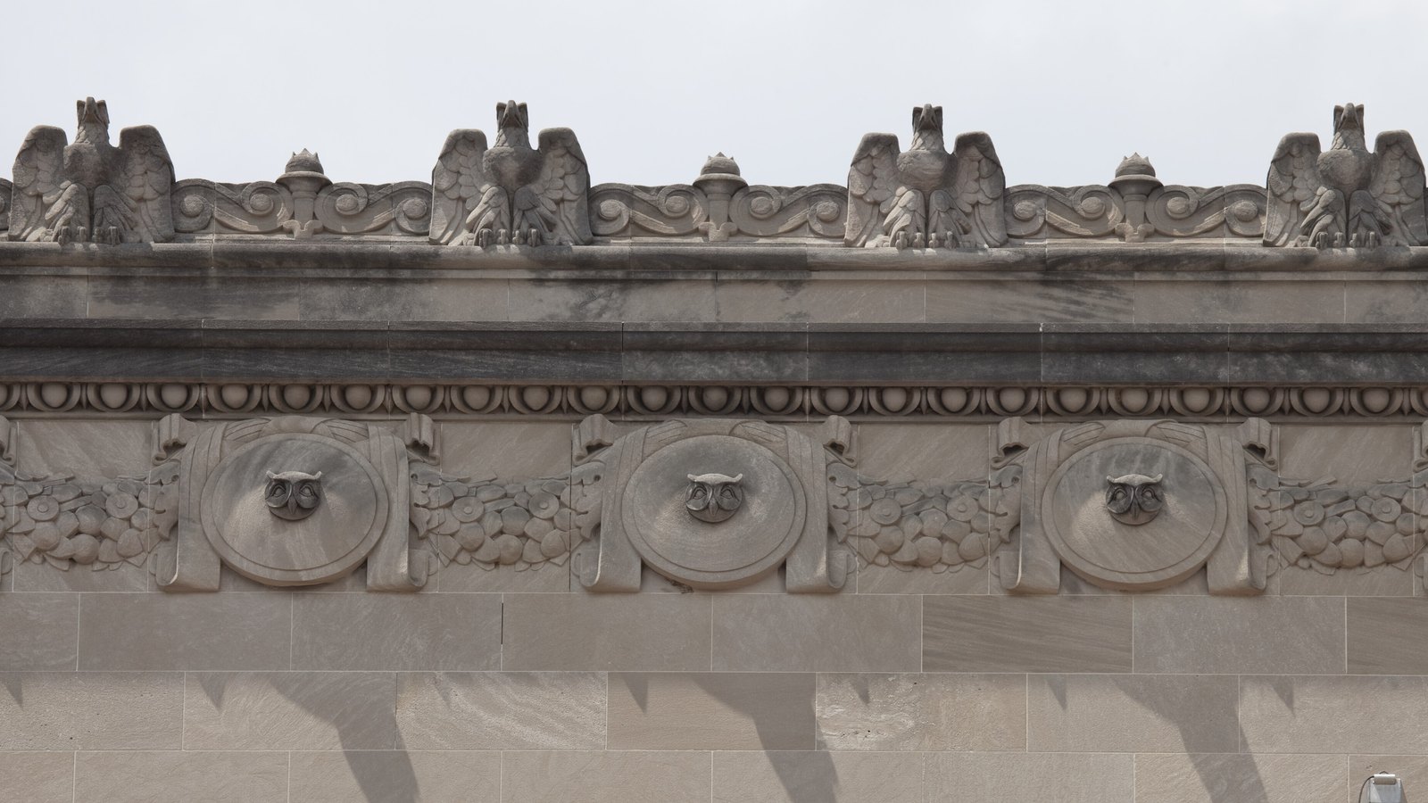 Stone eagles and owl medallions on the Herbert C. Hoover Building in Washington.