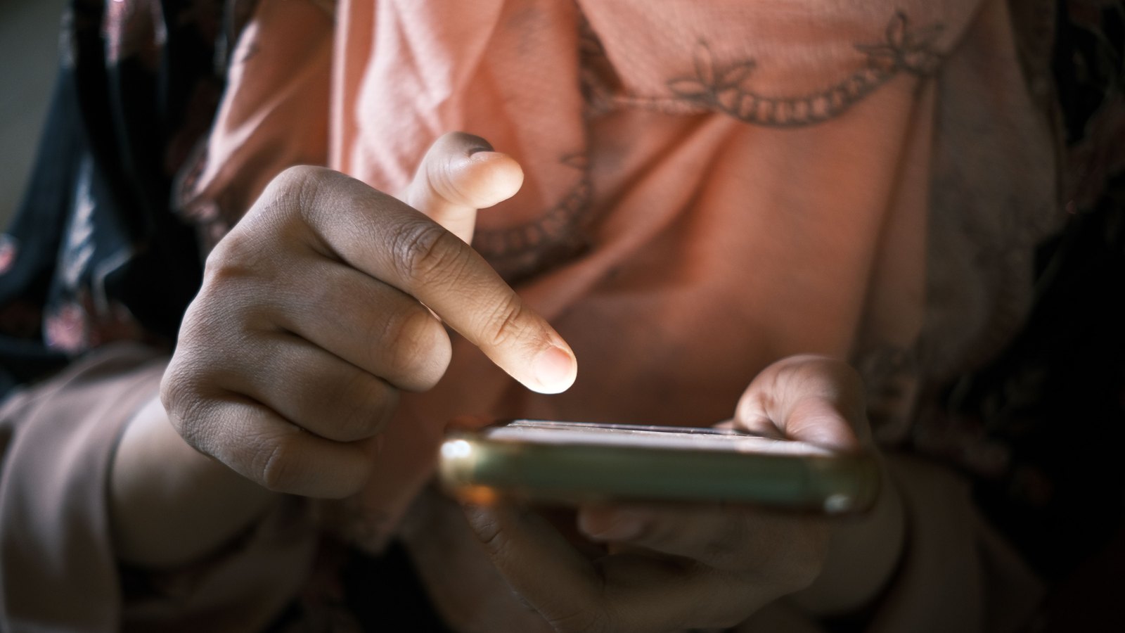 A photograph illustrating person scrolling phone.