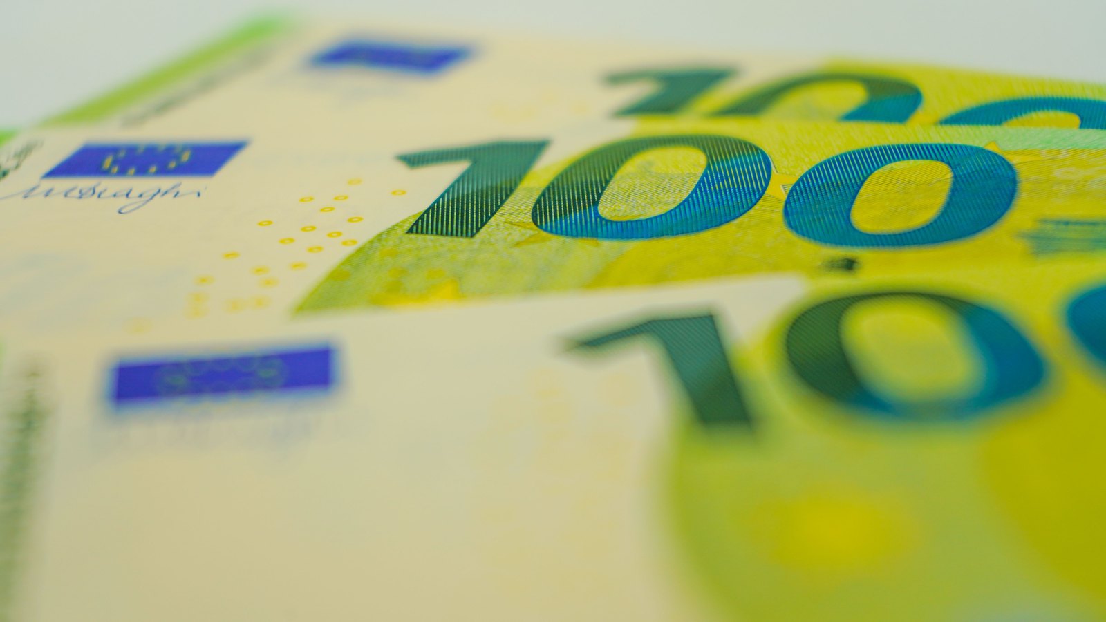 Close view of overlapping 100 euro banknotes.