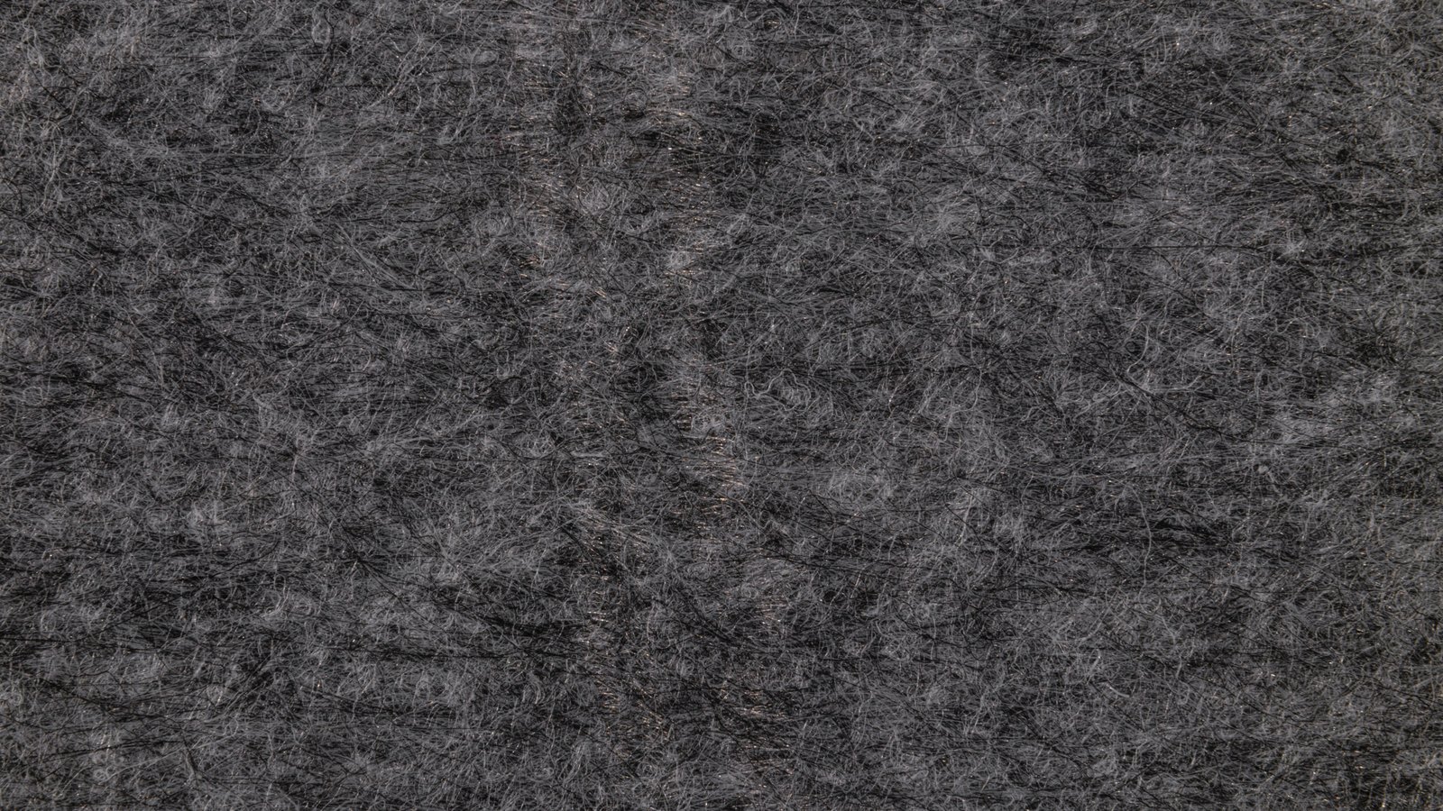 A photograph illustrating grey felt fabric texture macro.