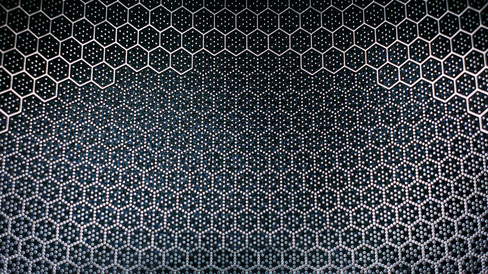 A dark blue-black surface covered in a honeycomb grid of pale outlined hexagons, large across the top of the frame and shrinking to a fine studded mesh toward the bottom.