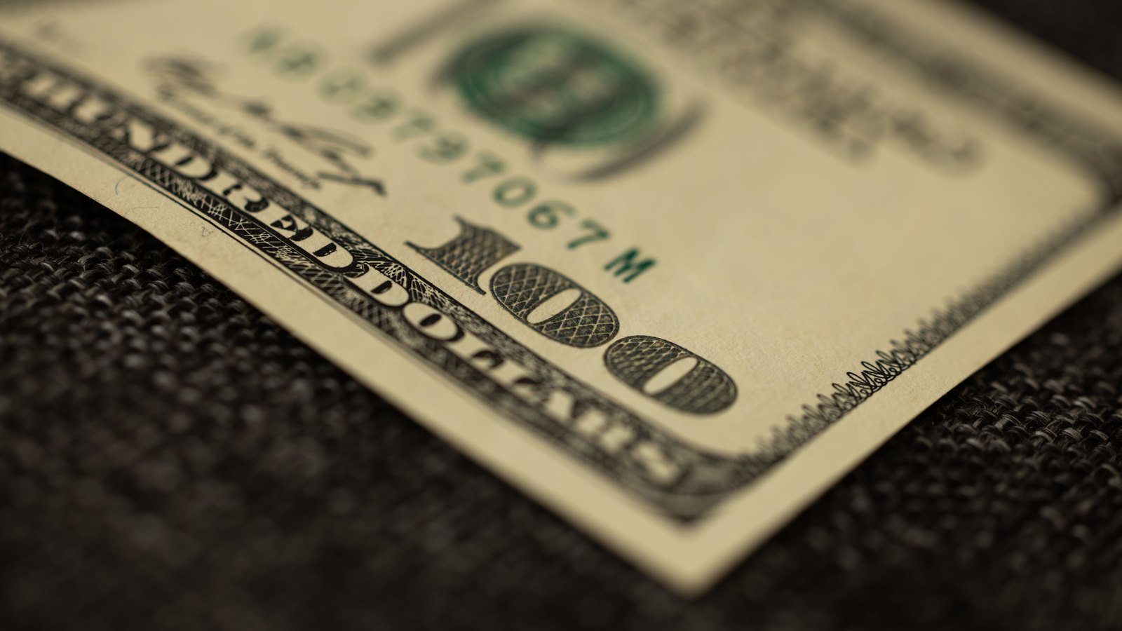 A photograph illustrating hundred dollar bills closeup.