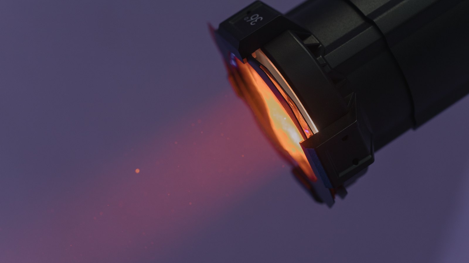 A black flashlight casts an orange beam in a dark close view, not a photograph of this search.
