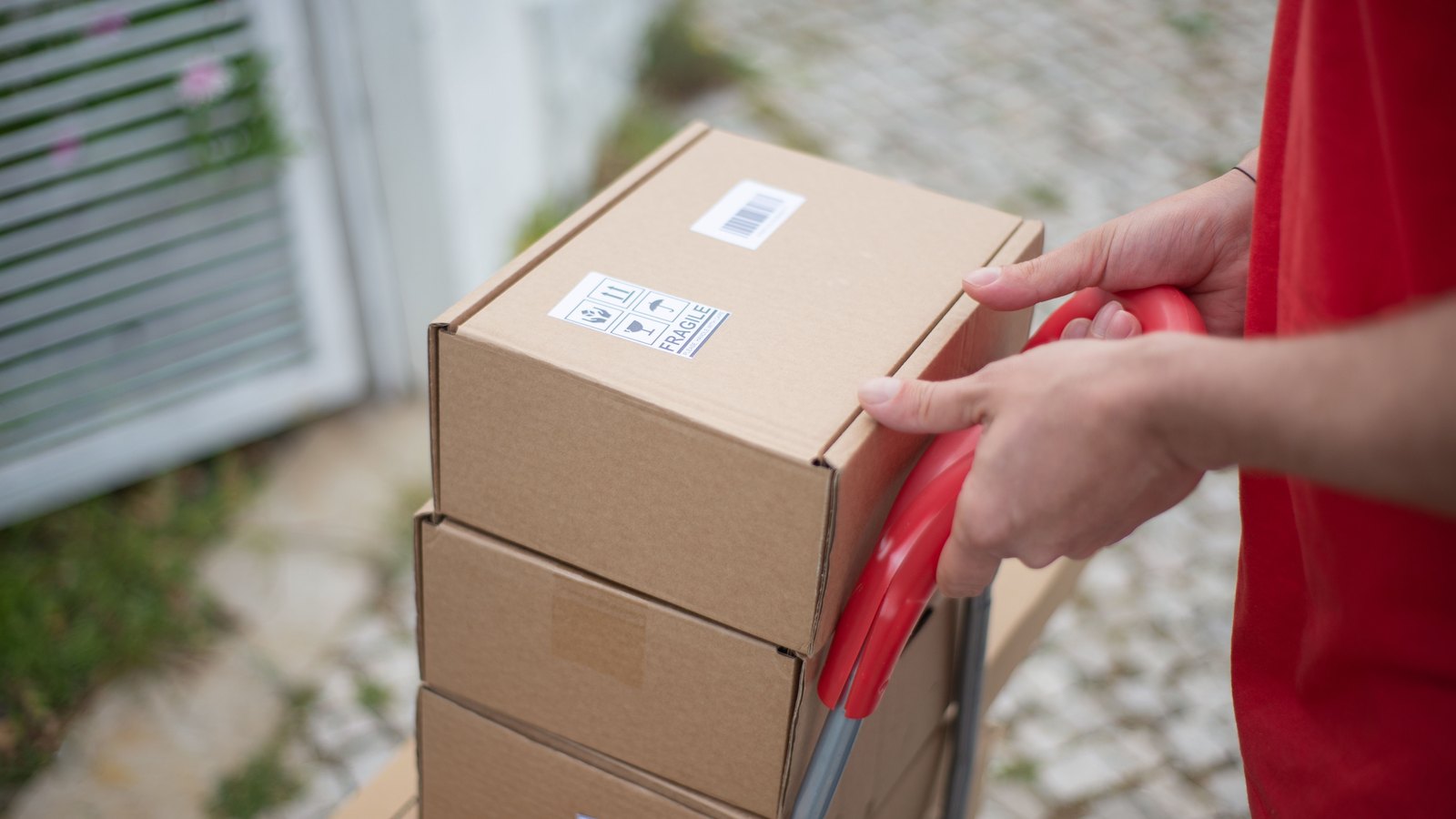 A photograph illustrating cardboard shipping boxes stacked.