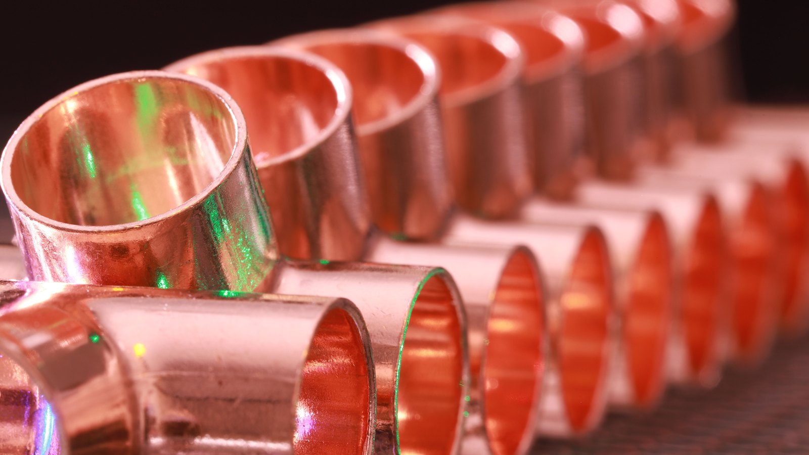 A photograph illustrating copper pipe ends stacked macro.