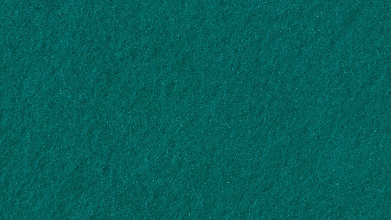 A close photograph of a sheet of dense teal felt filling the frame, the matted fibres running in soft irregular swirls with a faint sheen where they catch the light. No object, person, edge, marking or lettering is in view.