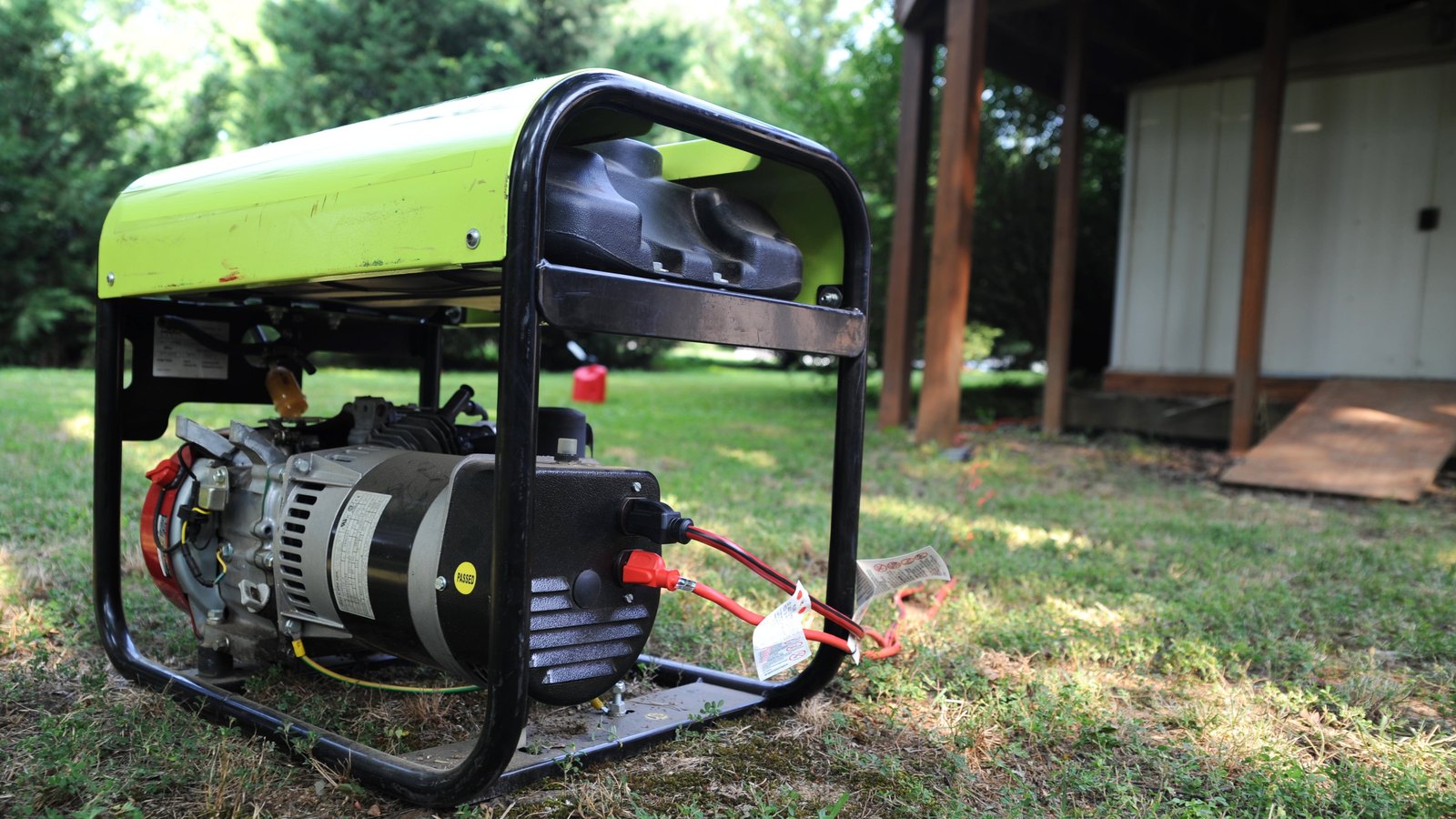 A portable generator stands outdoors beside a house. This federal stock photograph does not show Generators By Design.