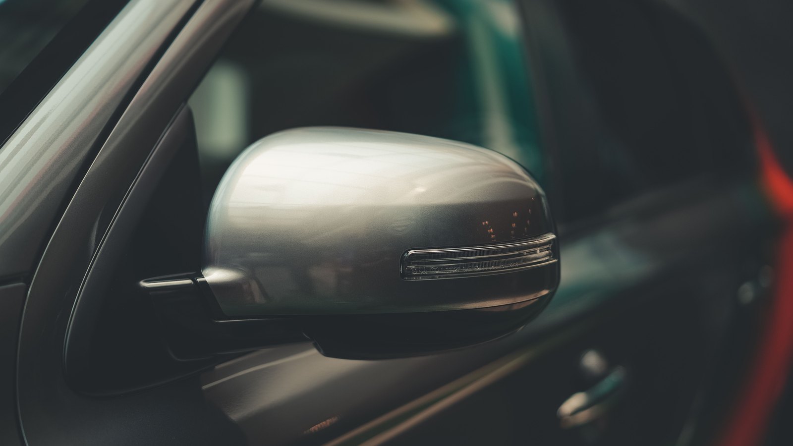 A photograph illustrating car side mirror closeup.