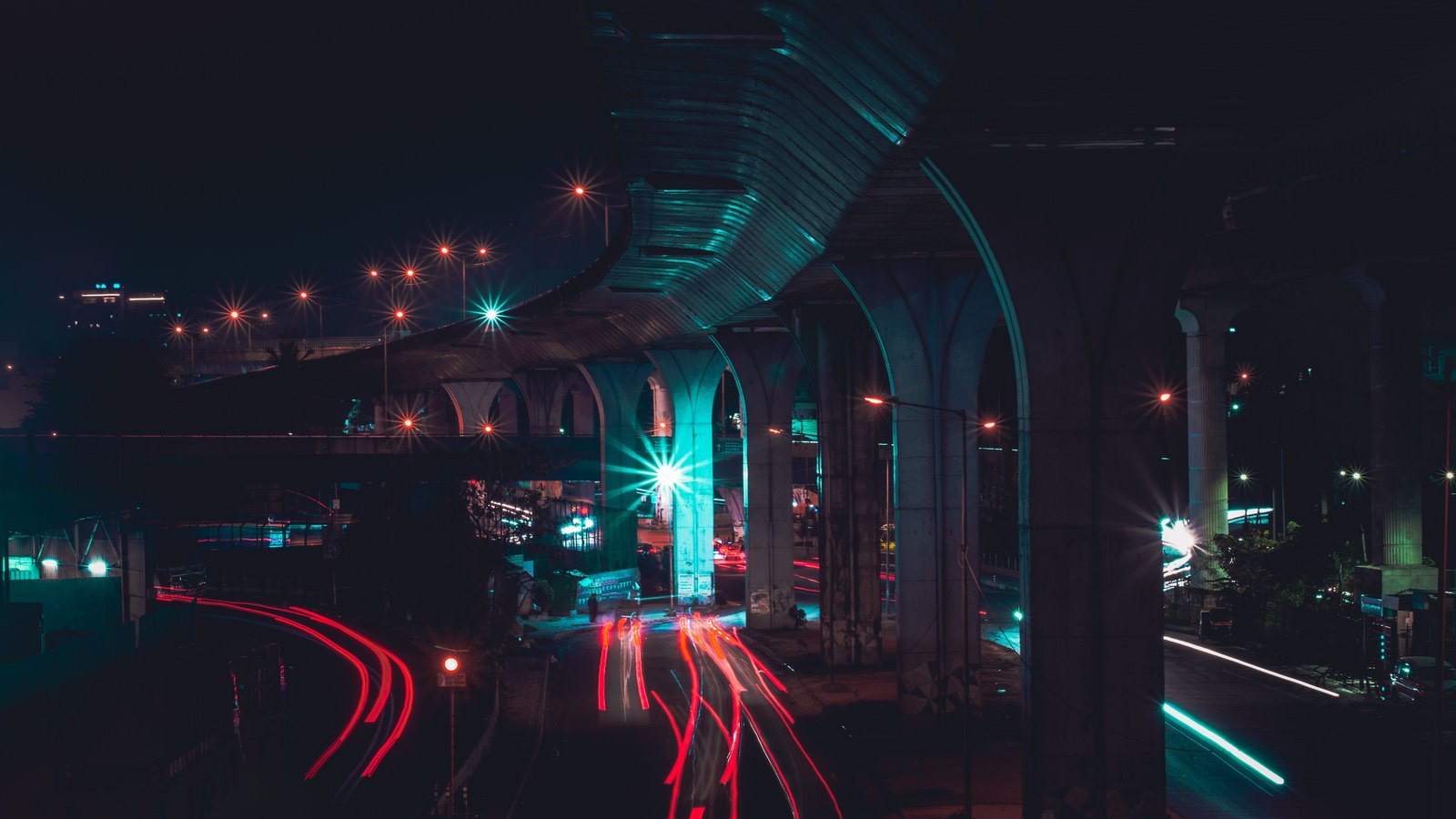 Vehicle light trails on an urban road at night.