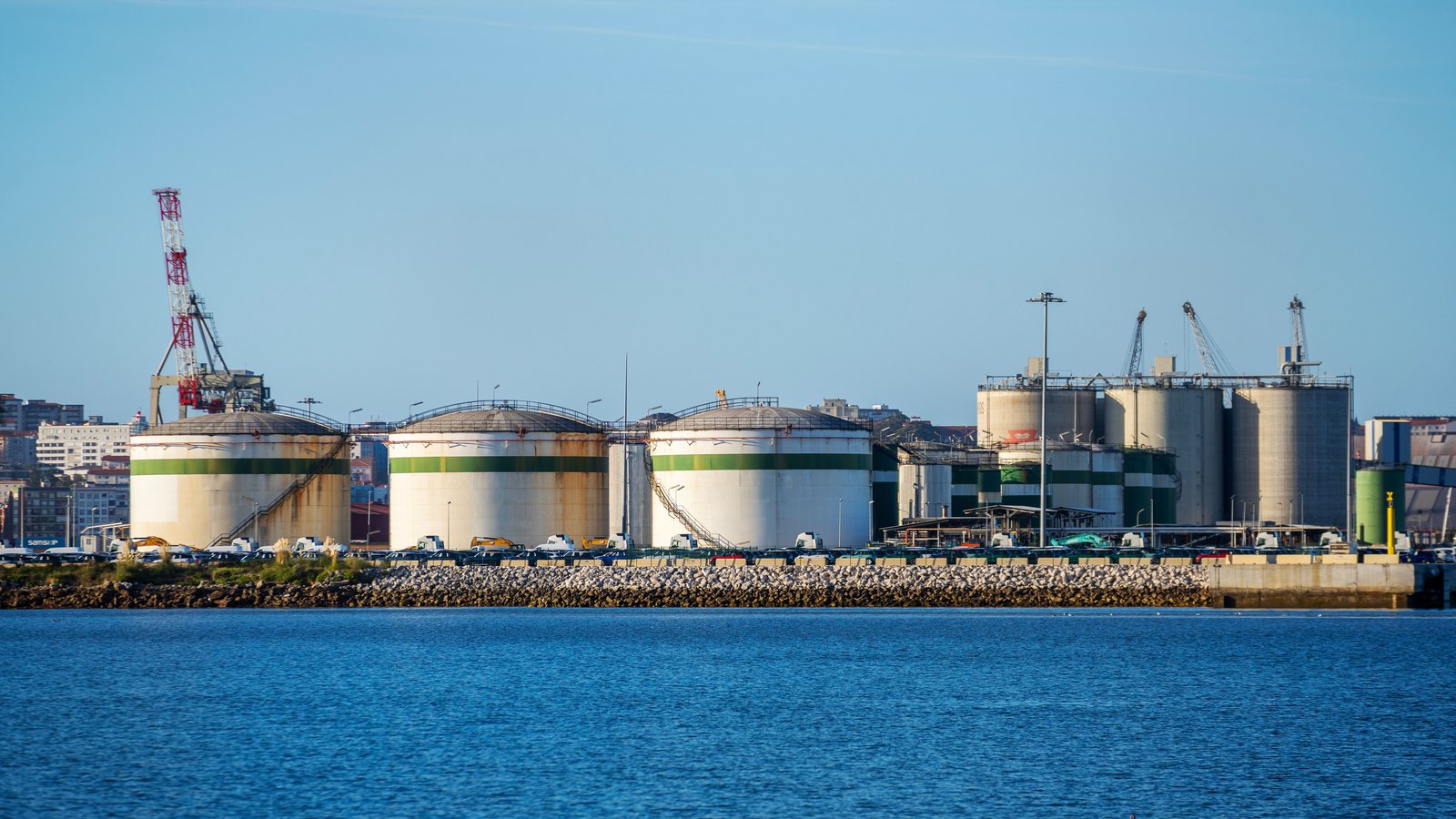 Oil storage tanks at a waterfront industrial terminal.