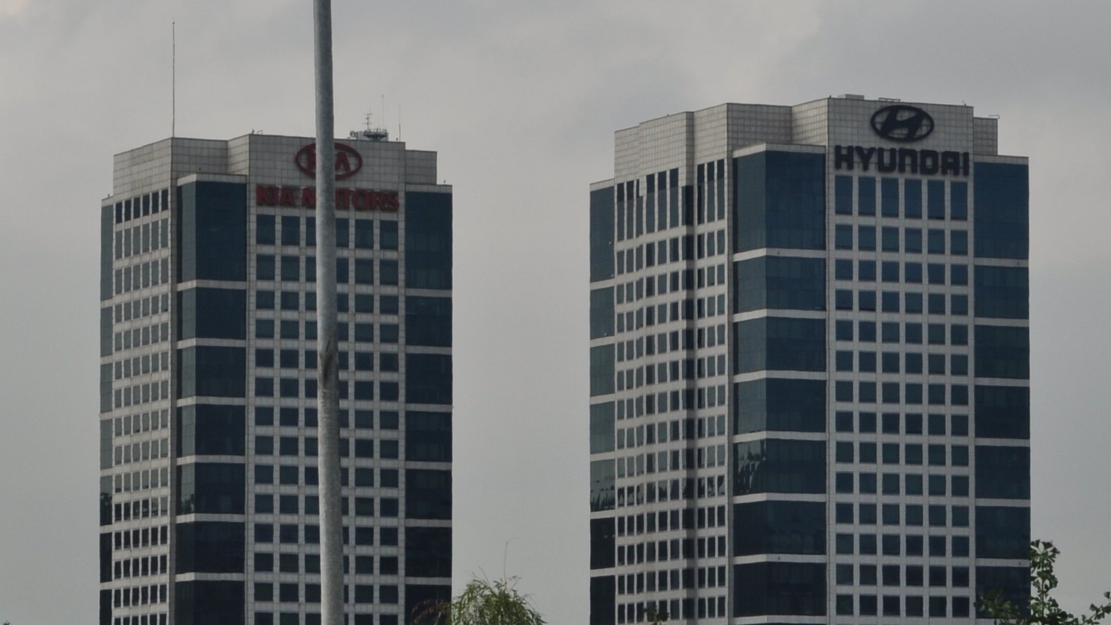 Kia and Hyundai headquarters towers in Seoul, with their company names on the upper facades, photographed in September 2010.