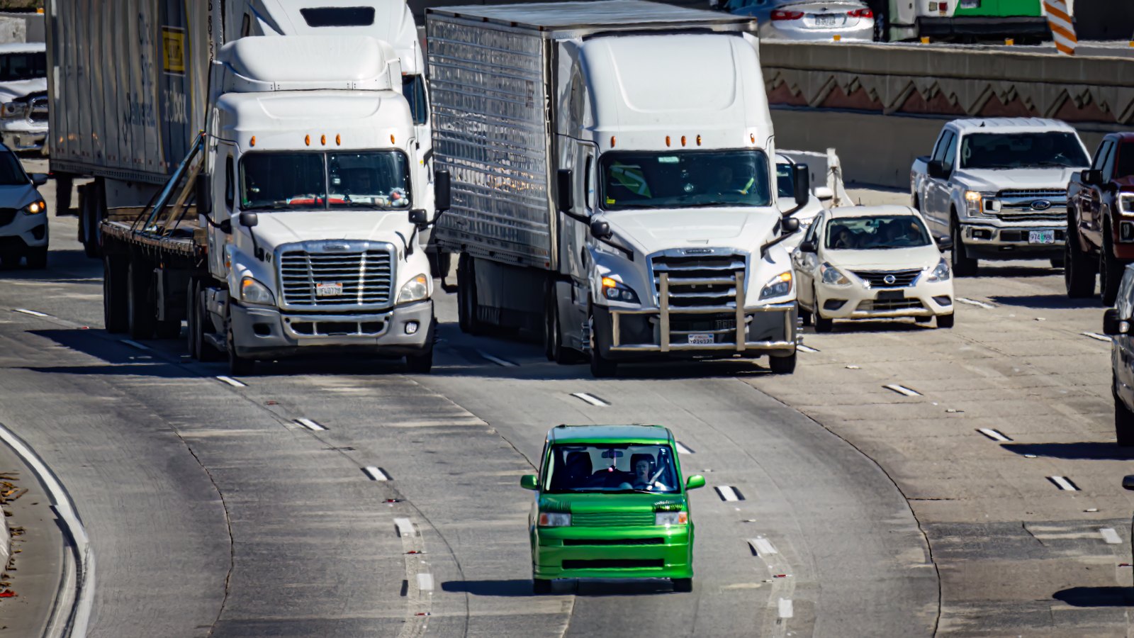 Lorries, pickups and cars travelling on a wide multi lane highway in the United States, seen head on with a long lens so the lanes compress together. No signage, place name or crash is visible in the frame. A plain photograph of unidentified traffic used as illustration, not a photograph of Interstate 75, of North Fort Myers or of this crash.