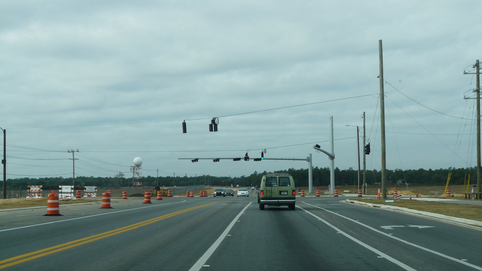 An emergency response vehicle and cones protect a highway incident scene, not a photograph of this crash.