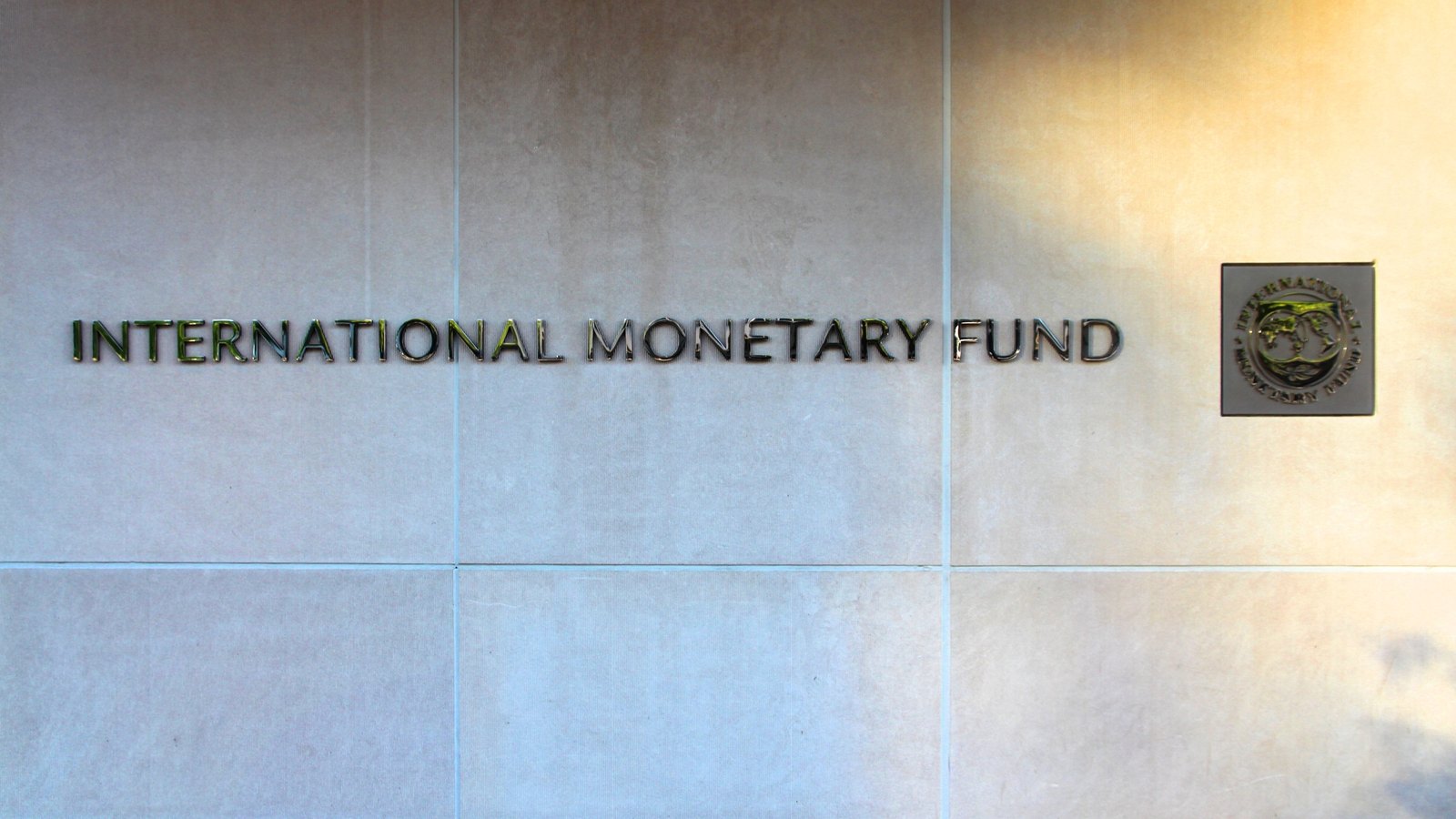 The International Monetary Fund name and seal on a wall at its Washington headquarters.