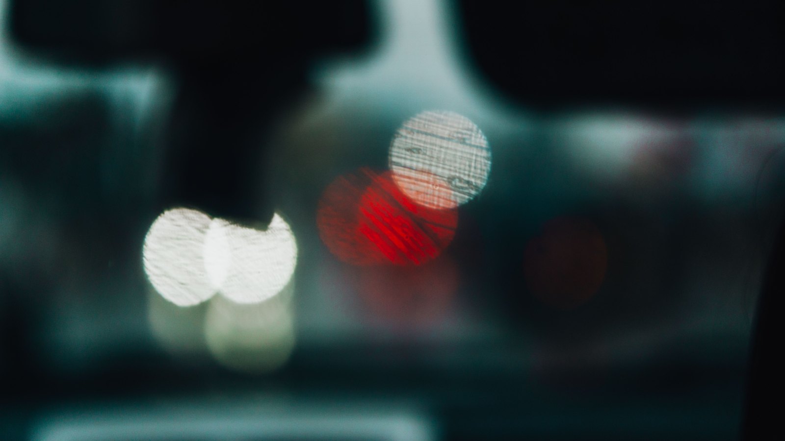 Blurred vehicle lights seen through a car interior at night, not a photograph of this event.