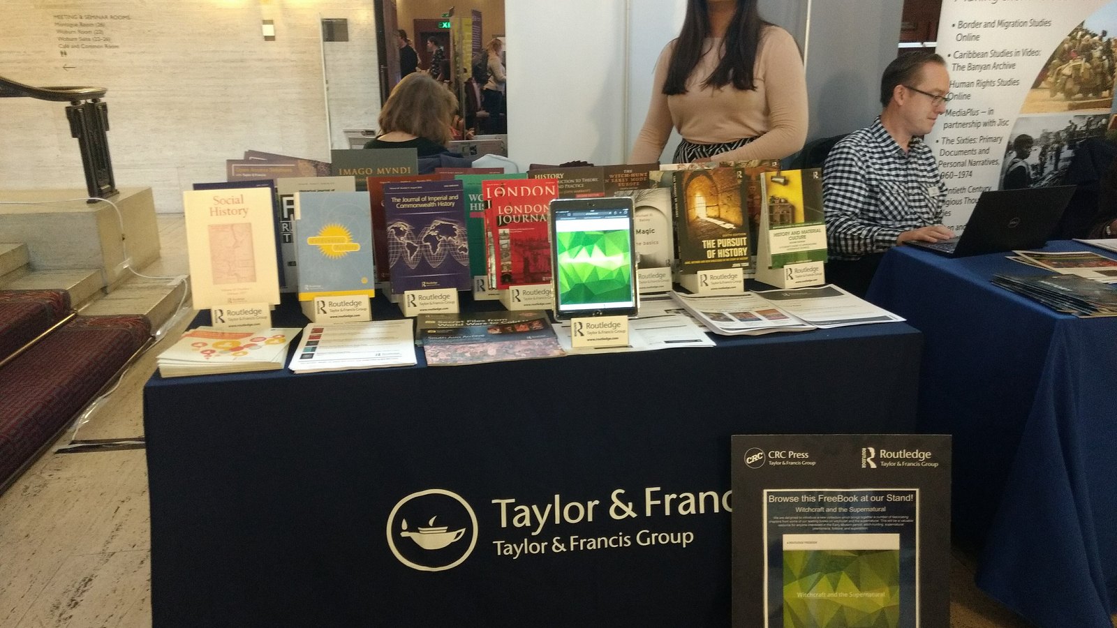 Books and journals fill a Taylor & Francis and Routledge display at a London history event.