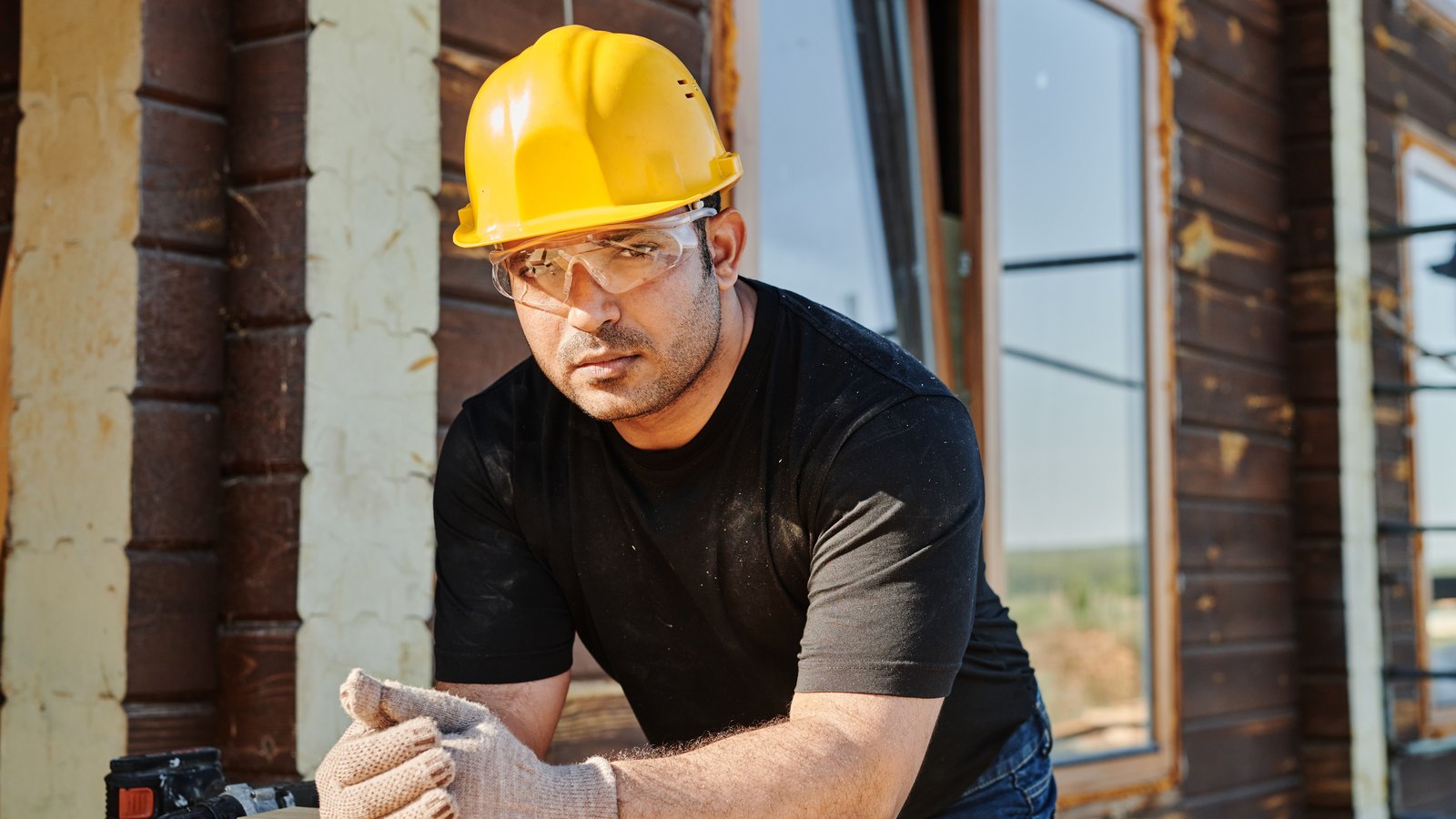 A photograph illustrating yellow hard hat on wood.