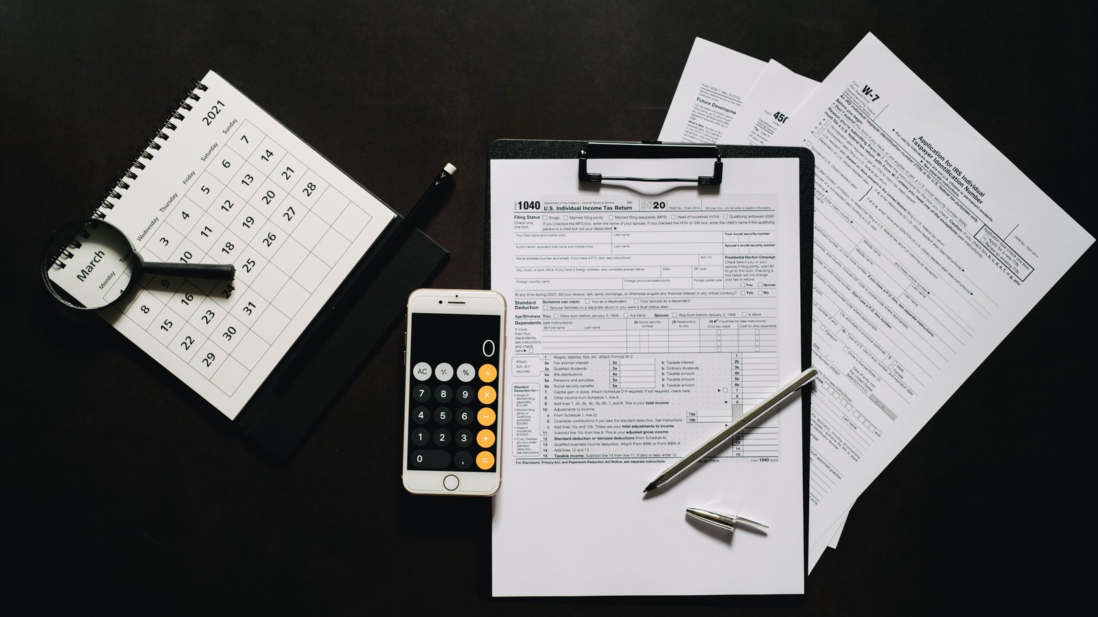 A photograph illustrating tax forms desk.
